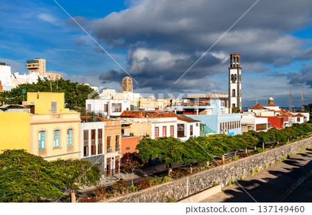 Scenic view of the colorful historic houses in the La Noria district and the tall bell tower of Iglesia de la Concepcion in Santa Cruz de Tenerife, Canary Islands. 137149460