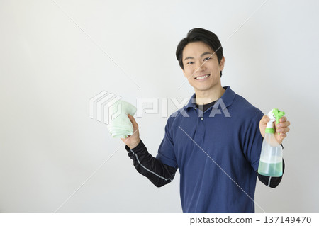 Cleaning staff holding towels and detergent spray 137149470