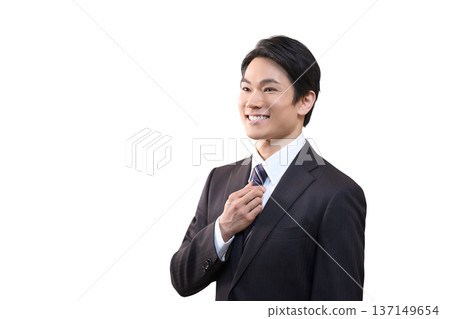 A refreshing businessman adjusting his tie (white background) A refreshing businessman adjusting his tie (white background) 137149654