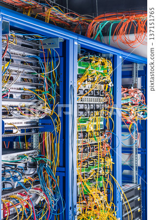 Server rack with fiber optic cables attached to front panel swit Server rack with fiber optic cables attached to front panel swit 137151765