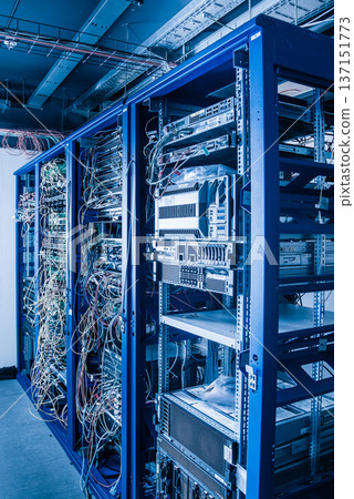 Server rack with fiber optic cables attached to front panel swit 137151773