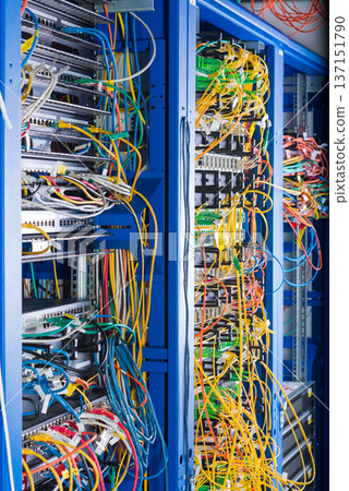 Server rack with fiber optic cables attached to front panel swit 137151790