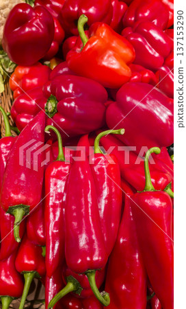 Red bell peppers in large boxes on store shelves. Vegetable display and sale. Red bell peppers in large boxes on store shelves. Vegetable display and sale. 137153290
