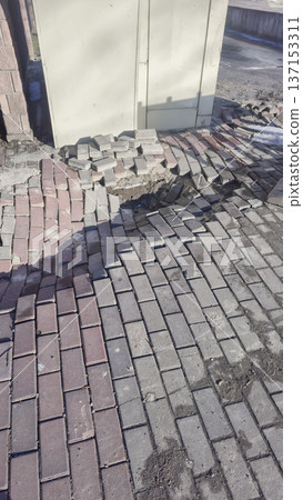 Road barrier covering collapsed asphalt Road repair work Danger zone in the park Road barrier covering collapsed asphalt Road repair work Danger zone in the park 137153311