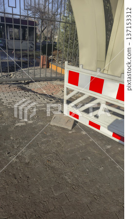 Road barrier covering collapsed asphalt Road repair work Danger zone in the park 137153312
