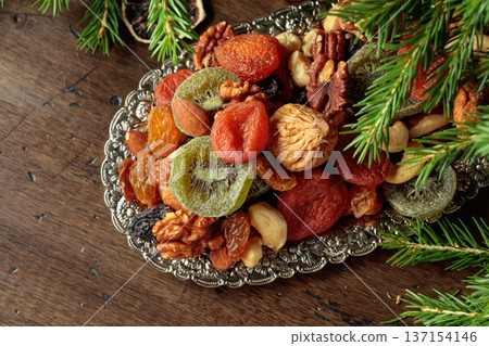 Assorted dried fruits and nuts on a silver tray. Assorted dried fruits and nuts on a silver tray. 137154146