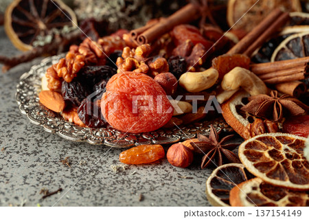 Dried fruits and nuts on a silver try. Dried fruits and nuts on a silver try. 137154149