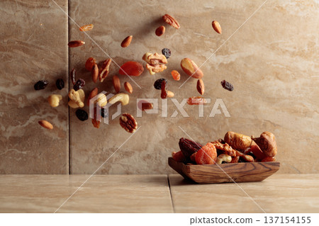 Mix of dried fruits and nuts in motion. Mix of dried fruits and nuts in motion. 137154155