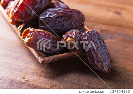 Juicy ripe dates on an old wooden table. Juicy ripe dates on an old wooden table. 137154180