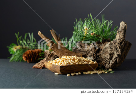 Peeled pine nuts with cedar dried snags and green branches. 137154184