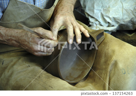 master craftsman working one of his creations master craftsman working one of his creations 137154263