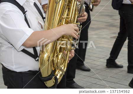 music band with person in the foreground playing the saxophone 137154562