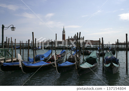 gondola moored in one of the canals of Venice gondola moored in one of the canals of Venice 137154804