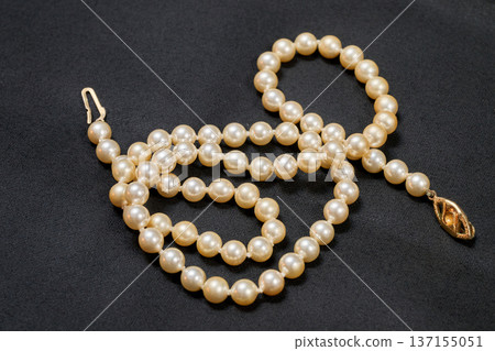 Antique pearl necklace on a black background 137155051