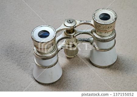 pair of old and worn opera glasses 137155052