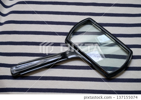Large rectangular reading magnifying glass on a lined background Large rectangular reading magnifying glass on a lined background 137155074