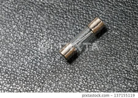 small transparent fuse on a leather background 137155119