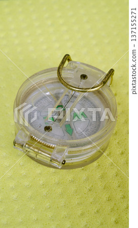 little scout plastic compass isolated on yellow background little scout plastic compass isolated on yellow background 137155271