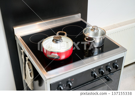 Two saucepans placed on an electric stove 137155338