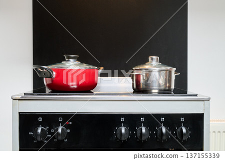 Two saucepans placed on an electric stove Two saucepans placed on an electric stove 137155339