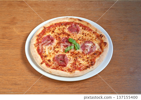Pizza Salami on white plate on wooden table Pizza Salami on white plate on wooden table 137155400