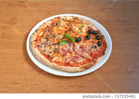 Pizza Four seasons on white plat on wooden table 137155401