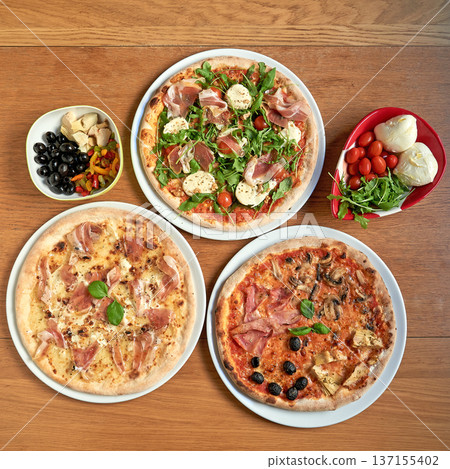 Three nice  pizza  on white plat on wooden table 137155402