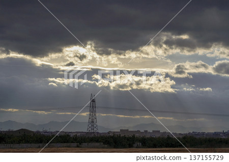 high voltage tower covered by black clouds high voltage tower covered by black clouds 137155729