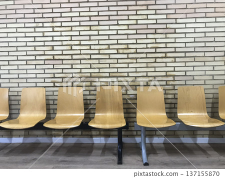 wooden seating with brick back wall in hospital waiting room wooden seating with brick back wall in hospital waiting room 137155870