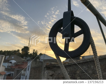 metal pulley with rope and out-of-focus rural background 137156213