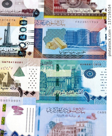 Sudanese pound paper banknotes pile on table. Sudan SDG currency money bills in big amount. Concept of economics, taxation and banking in Sudan 137156584
