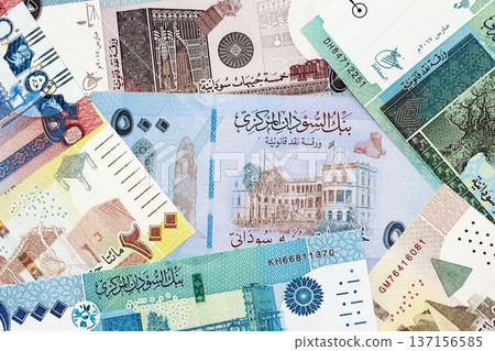 Sudanese pound paper banknotes pile on table. Sudan SDG currency money bills in big amount. Concept of economics, taxation and banking in Sudan Sudanese pound paper banknotes pile on table. Sudan SDG currency money bills in big amount. Concept of economics, taxation and banking in Sudan 137156585