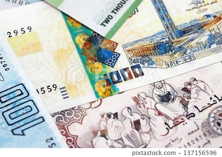 Algerian dinar paper banknotes pile on table. Algeria DZD currency money bills in big amount. Concept of economics, taxation and banking in Algeria Algerian dinar paper banknotes pile on table. Algeria DZD currency money bills in big amount. Concept of economics, taxation and banking in Algeria 137156596
