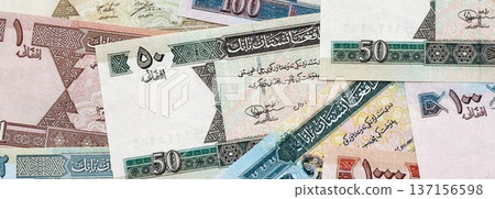 Afghan afghani paper banknotes pile on table. Afghanistan AFN currency money bills in big amount. Concept of economics, taxation and banking in Afghanistan Afghan afghani paper banknotes pile on table. Afghanistan AFN currency money bills in big amount. Concept of economics, taxation and banking in Afghanistan 137156598