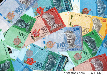 Malaysian ringgit paper banknotes pile on table. Malaysia MYR currency money bills in big amount. Concept of economics, taxation and banking in Malaysia Malaysian ringgit paper banknotes pile on table. Malaysia MYR currency money bills in big amount. Concept of economics, taxation and banking in Malaysia 137156630