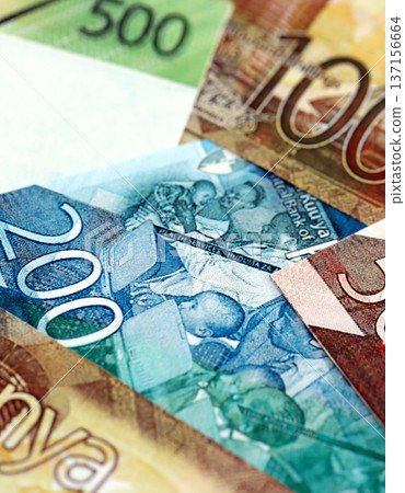 Kenyan shilling paper banknotes pile on table. Kenya KES currency money bills in big amount. Concept of economics, taxation and banking in Kenya 137156664