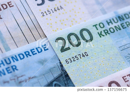 Danish krone paper banknotes pile on table. Denmark DKK currency money bills in big amount. Concept of economics, taxation and banking in Denmark Danish krone paper banknotes pile on table. Denmark DKK currency money bills in big amount. Concept of economics, taxation and banking in Denmark 137156675