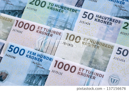 Danish krone paper banknotes pile on table. Denmark DKK currency money bills in big amount. Concept of economics, taxation and banking in Denmark Danish krone paper banknotes pile on table. Denmark DKK currency money bills in big amount. Concept of economics, taxation and banking in Denmark 137156676