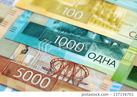 Russian ruble paper banknotes pile on table. Russia RUB currency money bills in big amount. Concept of economics, taxation and banking in Russia Russian ruble paper banknotes pile on table. Russia RUB currency money bills in big amount. Concept of economics, taxation and banking in Russia 137156701