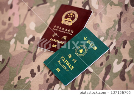 Chinese and Taiwan passports on table close up. Official identification document book for citizens of China. Concept of travel and tourism Chinese and Taiwan passports on table close up. Official identification document book for citizens of China. Concept of travel and tourism 137156705