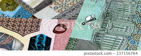 Omani rial paper banknotes pile on table. Oman OMR currency money bills in big amount. Concept of economics, taxation and banking in Oman Omani rial paper banknotes pile on table. Oman OMR currency money bills in big amount. Concept of economics, taxation and banking in Oman 137156764