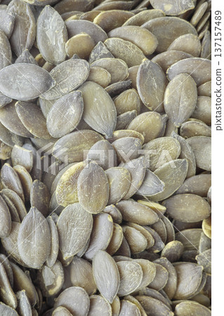 Close up of shelled pumpkin seeds. 137157489