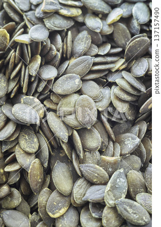 Close up of shelled pumpkin seeds. Close up of shelled pumpkin seeds. 137157490