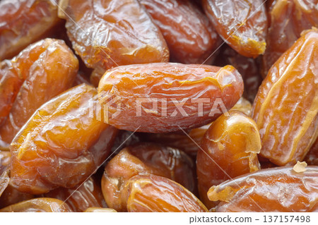 Close up photo of ripe pitted dates, selective focus. 137157498
