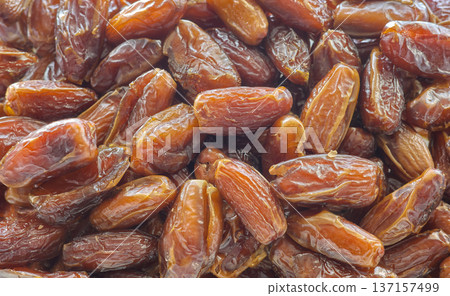 Close up photo of ripe pitted dates, selective focus. 137157499
