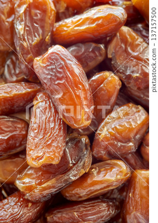 Close up photo of ripe pitted dates, selective focus. Close up photo of ripe pitted dates, selective focus. 137157500