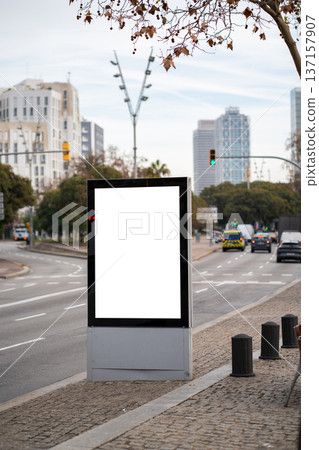 Blank vertical outdoor advertising screen in an urban environment providing space for promotional campaigns, showcasing a cityscape with traffic and modern architecture in the background Blank vertical outdoor advertising screen in an urban environment providing space for promotional campaigns, showcasing a cityscape with traffic and modern architecture in the background 137157907