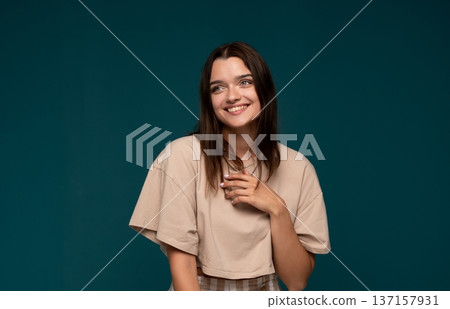 Young woman smiling, expressing genuine happiness and joy, looking away with a positive, candid expression 137157931