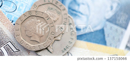 Coins and banknotes of United Kingdom and Great Britain pound currency. UK money close up. Business, economy and finance concept Coins and banknotes of United Kingdom and Great Britain pound currency. UK money close up. Business, economy and finance concept 137158066