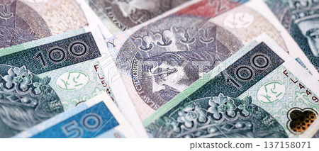 Big amount of polish zloty money banknotes close up. Huge pile of cash of Poland currency. Concept of business, economy and investment in Poland Big amount of polish zloty money banknotes close up. Huge pile of cash of Poland currency. Concept of business, economy and investment in Poland 137158071